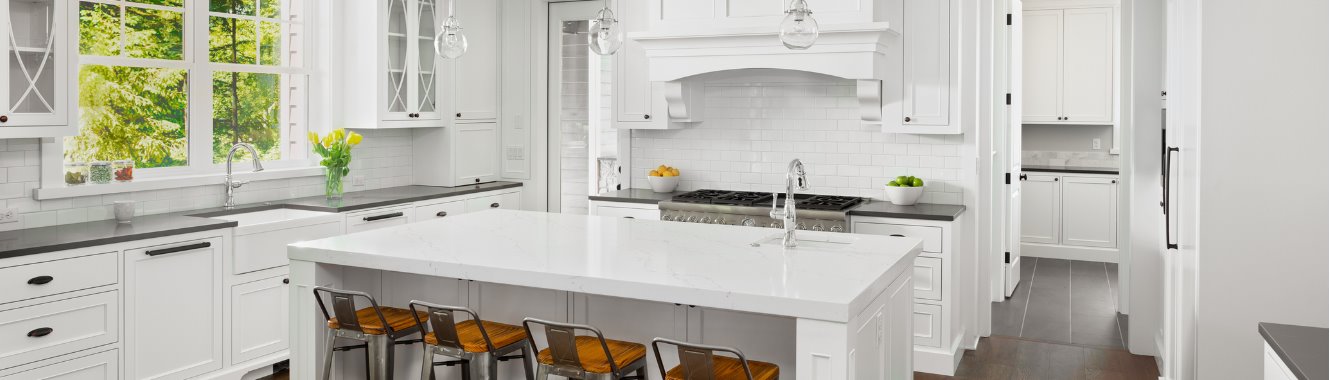 Kitchen with white cabinets and a large island.